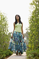 Woman in flowing skirt, walking on pathway - Vivek Sharma