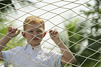 boy looking through net - Alex Mares-Manton