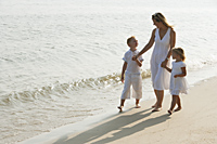 woman walking on beach with children - Alex Mares-Manton