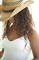 Woman wearing straw hat, looking down - Alex Mares-Manton