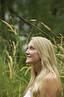 Blond woman in field, smiling - Alex Mares-Manton
