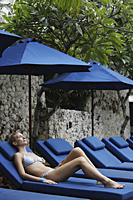 woman in bathing suit on blue lounge chair - Alex Mares-Manton