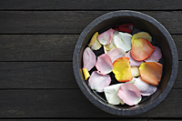 Petals floating in wooden bowl - Nugene Chiang