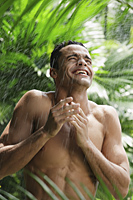 man standing in tropical rain - Alex Mares-Manton