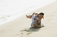 woman tickling girl on beach - Alex Mares-Manton