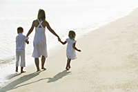 woman walking on beach with children - Alex Mares-Manton