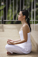 woman wearing all white, meditating - Alex Mares-Manton
