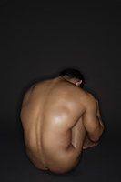 muscular man curled up - Alex Mares-Manton
