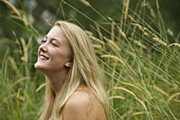 Blond woman in field, laughing - Alex Mares-Manton