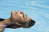 woman floating in pool - Alex Mares-Manton