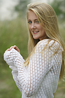 Woman wearing white sweater, smiling - Alex Mares-Manton