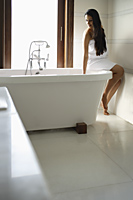 woman testing bath water - Alex Mares-Manton