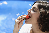 Woman eating strawberry - Alex Mares-Manton