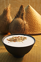 Coconuts, hat, bowl of natural body scrub - Ellery Chua