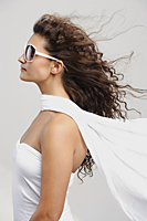 Profile of woman wearing white glasses and scarf - Alex Mares-Manton