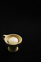 White candle in clay pot with handle - Nugene Chiang