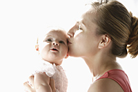 Mother kissing baby girl - Alex Mares-Manton