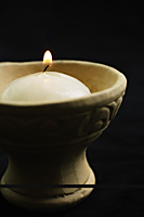 White candle in clay pot with handle - Nugene Chiang