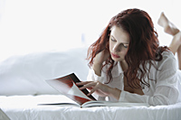 Woman reading on bed - Alex Mares-Manton