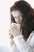 Woman sipping from coffee cup - Alex Mares-Manton