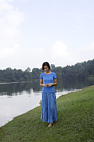 Teenage girl standing by lake - Ellery Chua