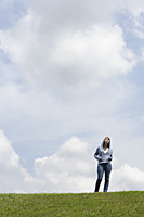 Teen girl standing on grass - Nugene Chiang
