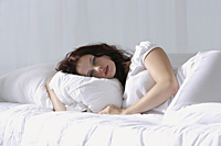 Woman resting in bed - Alex Mares-Manton
