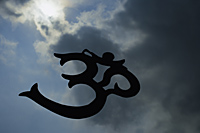 The word "Om" in Sanskrit, in front of clouds - Nugene Chiang