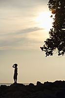 Silhouette of boy looking out to sea - Alex Mares-Manton