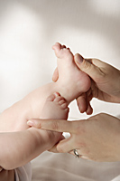 Hands holding baby's feet - Alex Mares-Manton