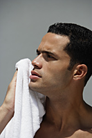 Man holding white towel to face - Alex Mares-Manton