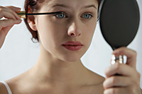 Woman applying mascara - Alex Mares-Manton