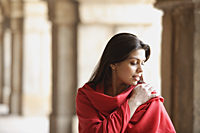 Woman in red shawl, hand on shoulder, in ancient monument - Alex Mares-Manton