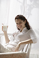 Woman holding glass of milk - Alex Mares-Manton