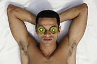 Man with kiwi slices on eyes - Alex Mares-Manton