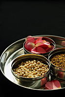 Silver platter of natural beauty items, and rose petals - Nugene Chiang