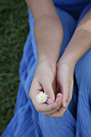 Hands holding tiny flower - Ellery Chua