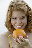 Girl holding orange - Nugene Chiang
