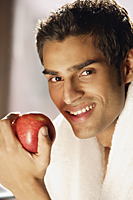 Man smiling with red apple - Alex Mares-Manton