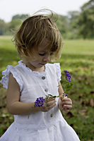 Little girl holding purple blossoms - Alex Mares-Manton