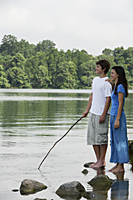 Teen couple standing in lake - Nugene Chiang