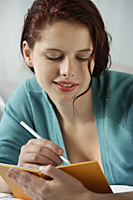 Woman writing in diary - Alex Mares-Manton