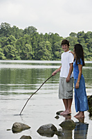 Teen couple standing in lake - Nugene Chiang