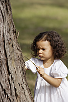 Little girl looking at tree - Alex Mares-Manton