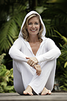Woman sitting on deck wearing all white - Alex Mares-Manton