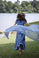 Teen girl running by lake with blue scarf - Ellery Chua