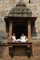 Couple sitting in ancient monument - Alex Mares-Manton