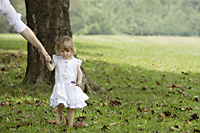 Little girl walking, holding woman's hand - Alex Mares-Manton