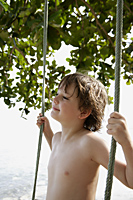 Boy standing on swing - Alex Mares-Manton
