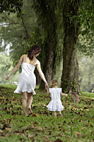 Mother and daughter walking away, wearing white - Alex Mares-Manton